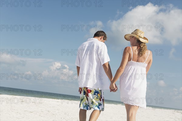 Couple walking on beach. Date : 2008