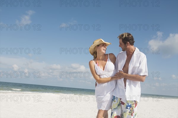 Couple walking on beach. Date : 2008