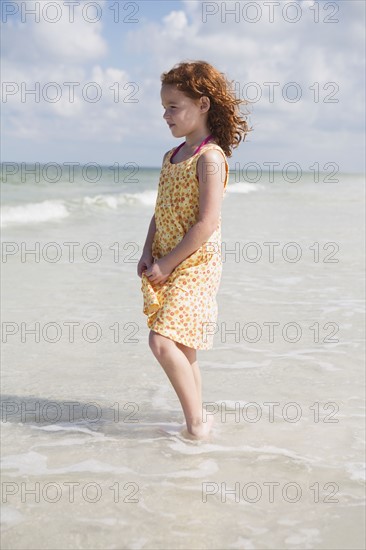 Girl wading in ocean. Date : 2008