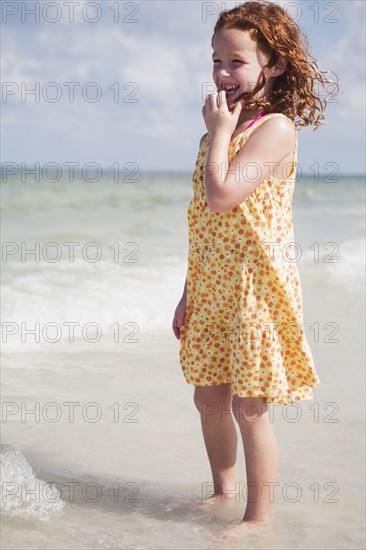 Girl wading in ocean. Date : 2008