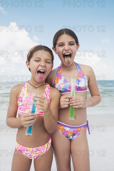 Girls eating ice pops on beach. Date : 2008