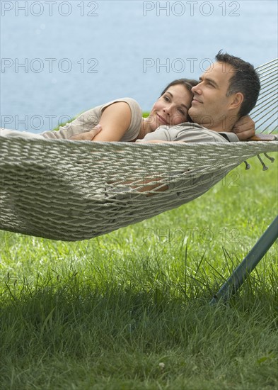 Couple laying in hammock.