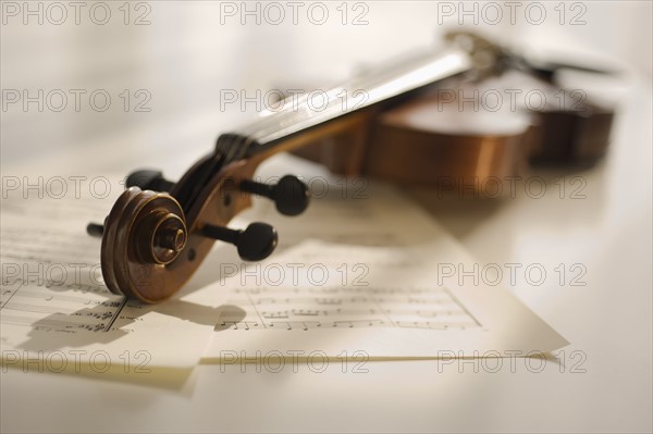 Violin laying on sheet music.