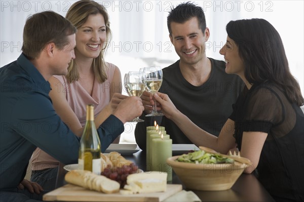 Couples toasting with wine glasses.