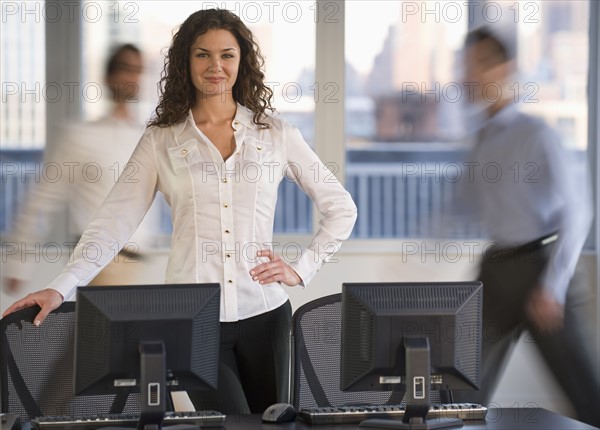 Businessman posing at desk.