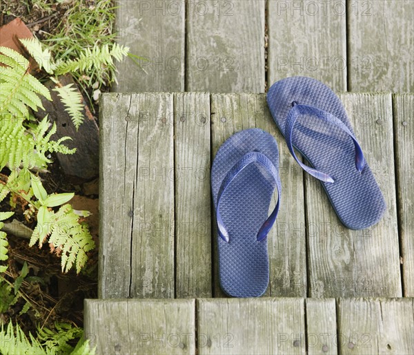 Flip-flops on wooden deck. Date : 2008