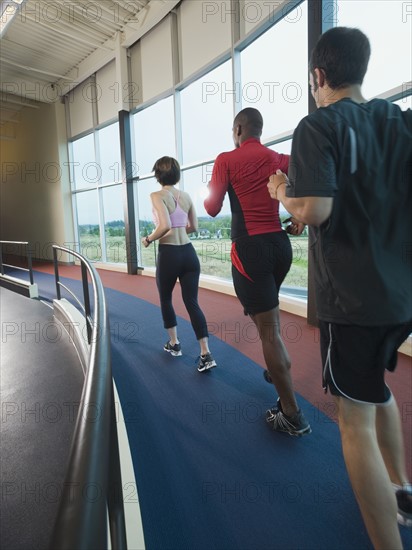 People running on indoor track. Date: 2008