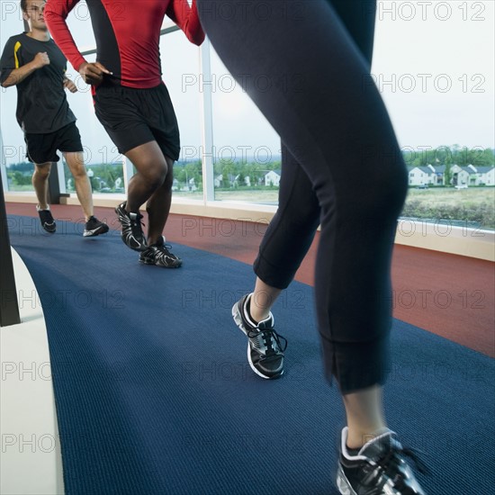 People running on indoor track. Date: 2008