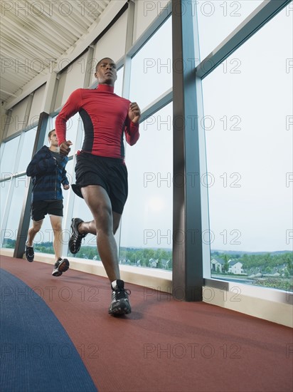 Men running on indoor track. Date : 2008