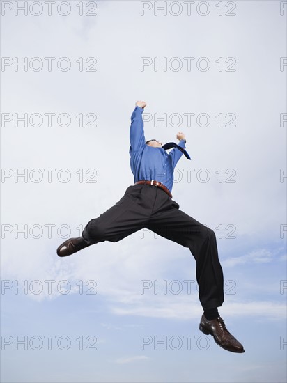 Businessman jumping in mid-air. Date: 2008