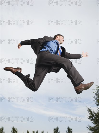 Businessman jumping in mid-air. Date : 2008