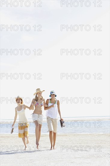 Young women walking on beach. Date : 2008