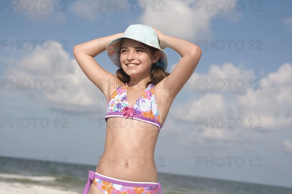 Portrait of girl on beach with hands behind head. Date: 2008