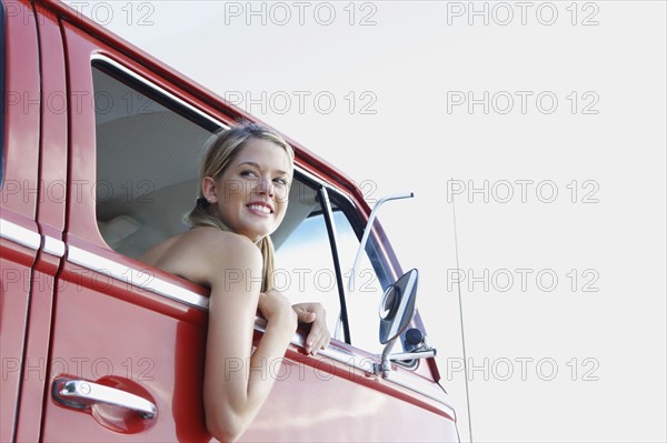 Young woman leaning out of van window. Date : 2008