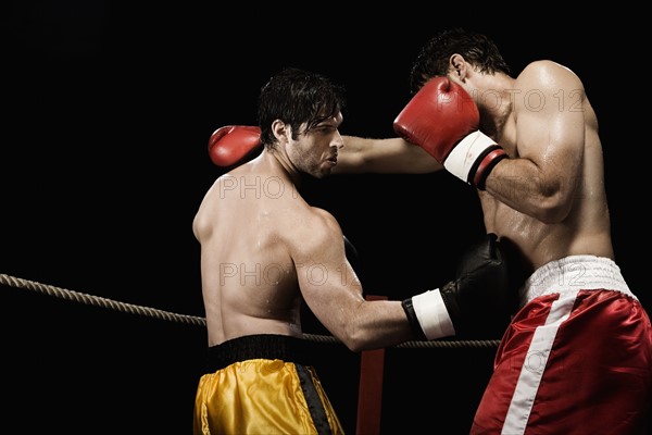 Boxers fighting in boxing ring. Date : 2008