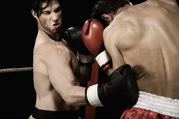 Boxers fighting in boxing ring. Date: 2008