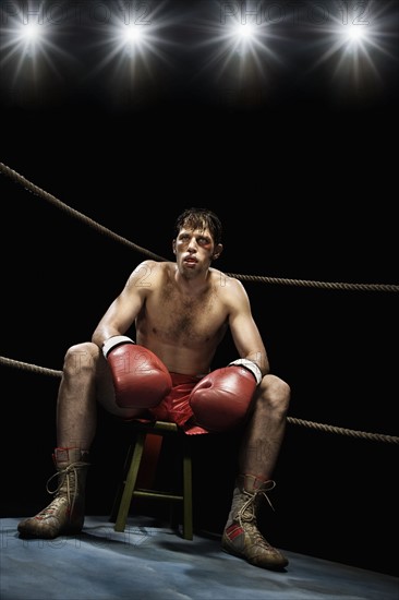 Boxer sitting on stool in corner of boxing ring. Date: 2008