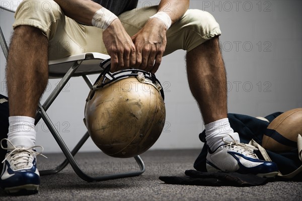 Football player sitting in locker room. Date : 2008