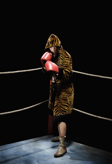 Boxer posing in fighting stance in boxing ring. Date : 2008