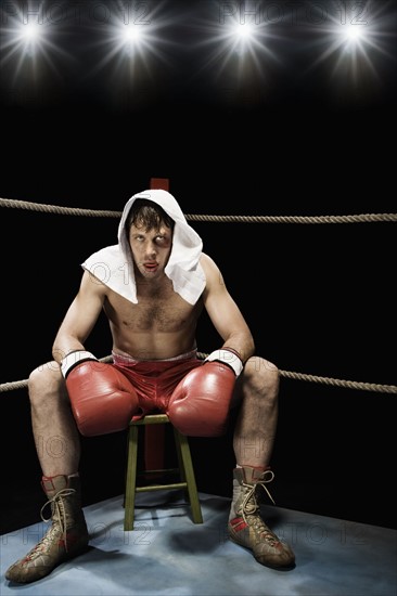 Boxer sitting on stool in corner of boxing ring. Date: 2008