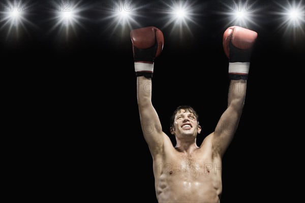 Boxer smiling with boxing gloves raised. Date: 2008