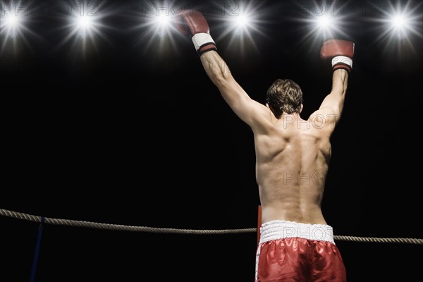 Boxer standing in boxing ring with gloves raised. Date : 2008