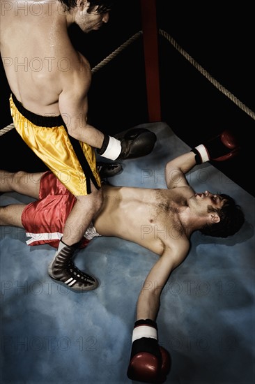 Boxer standing above knocked out opponent. Date : 2008