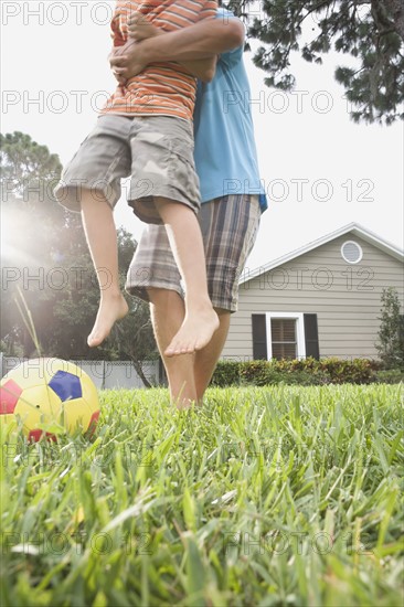 Father and son playing in backyard. Date : 2008
