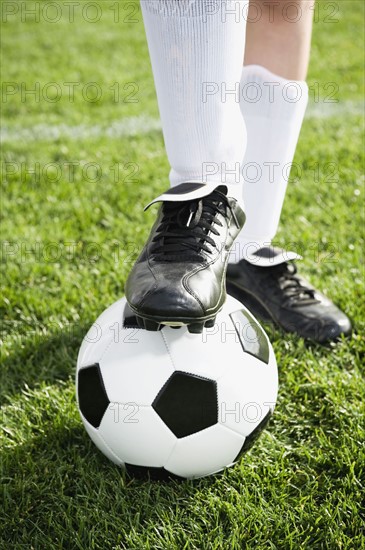 Close up of boy’s foot on soccer ball. Date: 2008