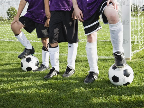 Boys standing near goal on soccer field. Date : 2008