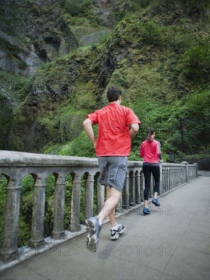 Couple running across bridge. Date: 2008