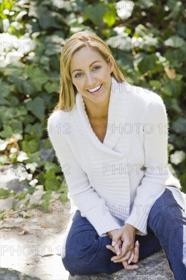 Portrait of smiling woman sitting in garden. Date: 2008