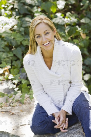 Portrait of smiling woman sitting in garden. Date : 2008