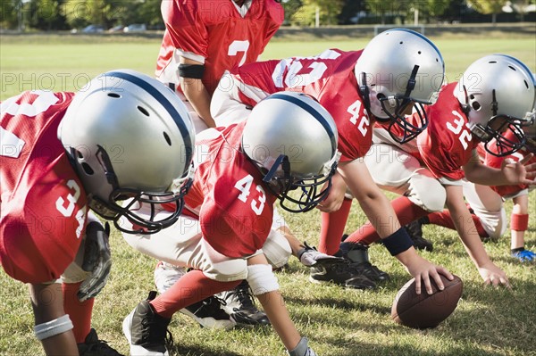 Football players at line of scrimmage ready to snap football. Date: 2008