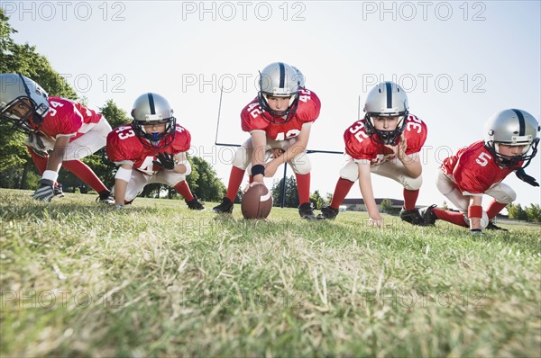 Football players at line of scrimmage ready to snap football. Date: 2008