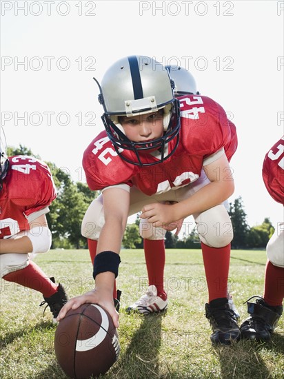 Football center preparing to snap football. Date: 2008