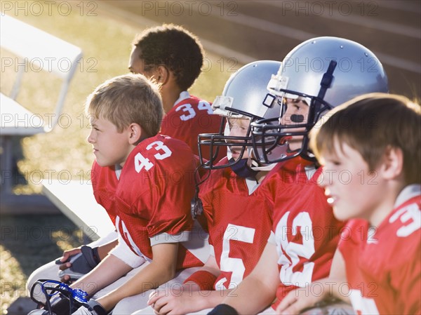 Football players sitting on bench. Date: 2008