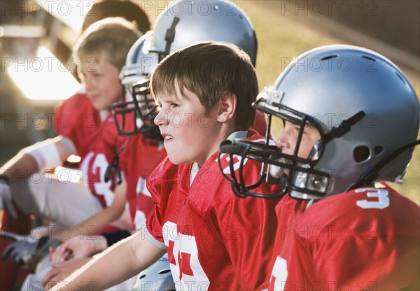 Football players sitting on bench. Date: 2008