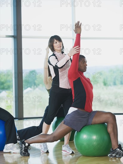 Instructor guiding fitness class. Date : 2008