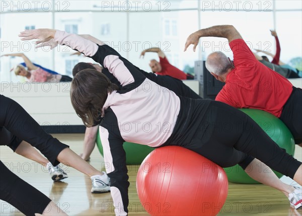Fitness class stretching on balance balls. Date : 2008