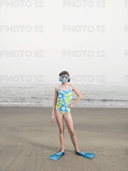 Girl on beach wearing flippers and snorkeling mask. Date : 2008