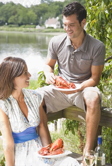 Couple eating lobster on deck. Date : 2008