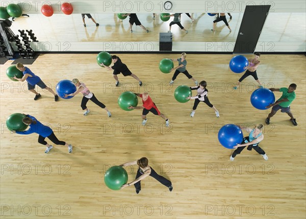 Fitness class holding balance balls. Date : 2008