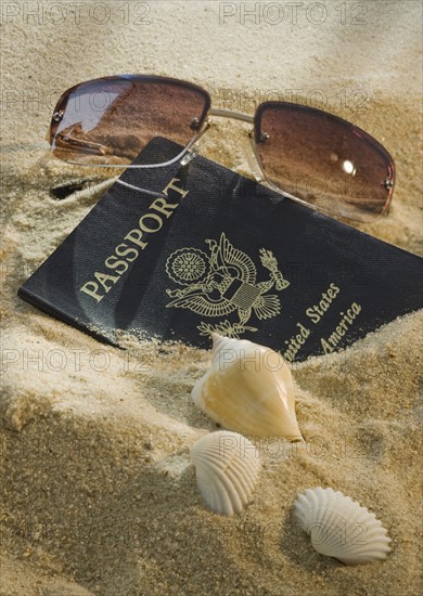 United States passport, sunglasses, and seashells.