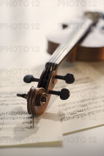 Violin laying on sheet music.