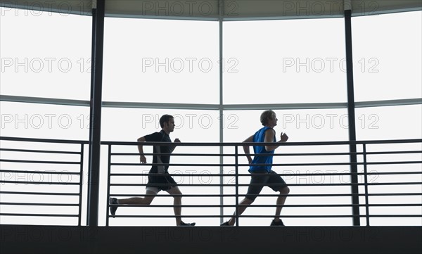 Men running on indoor track. Date: 2008