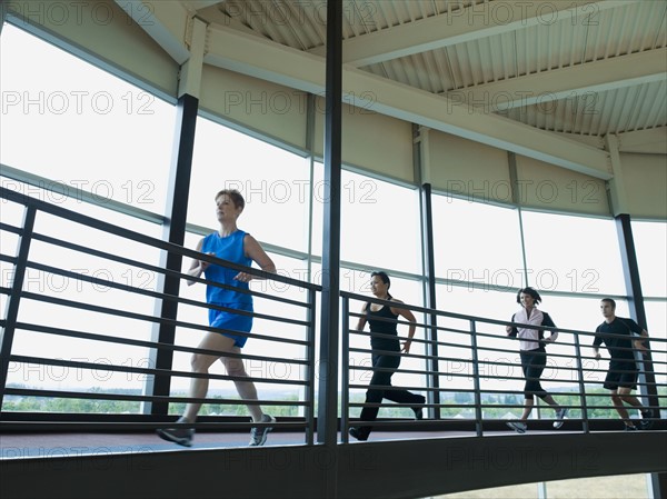 Men and women running on indoor track. Date: 2008