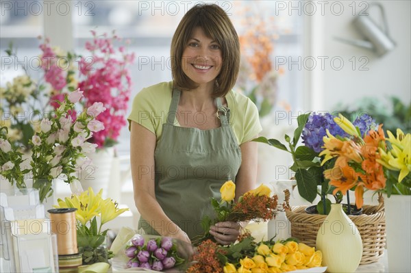 Portrait of florist arranging flowers.