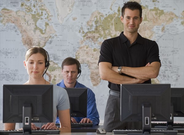 Call center employees with map in background.