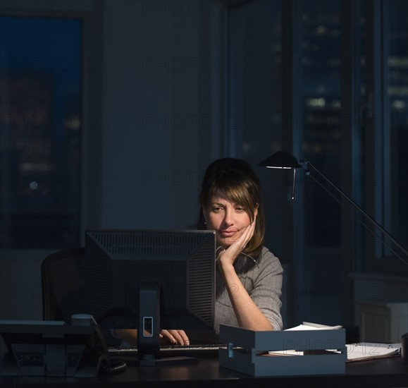 Businesswoman working late in office.